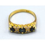 An 18ct. Gold Sapphire and Diamond Ring set with three sapphires and four diamonds, ring size O, 4.1
