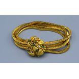 An 18ct. Gold Bracelet of quadruple flat link form, the cluster clasp set with emeralds and