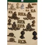 Card of various Royal Artillery related items including Shoulder Titles, Cap badges and Collar