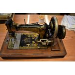 Frister and Rossmann, Berlin Antique Hand crank Sewing Machine in heavy oak case, with key