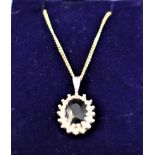 A 9ct Gold (White) with a deep blue coloured central stone on a 18ct Gold fine chain (45mm)