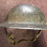 British WWII steel 'Brodie' helmet complete with liner and chin strap, stamped on the rim: F&L