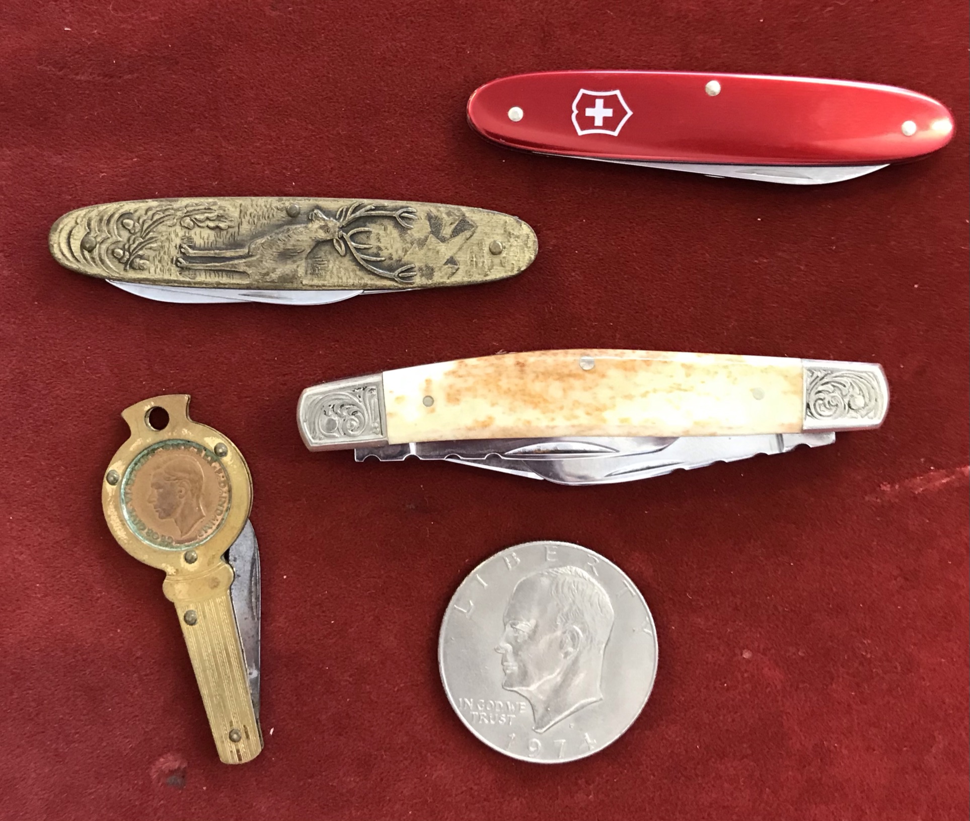 Penknives (4) and an American 1974 Dollar, Knives being very ornate, one with a bone handle made