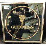 A Guinness Wall Clock modern, battery operated (untested) and a pair of Vintage enamelled