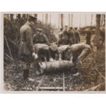 British WWI RP Press Publication Photograph showing a 15inch Howitzer Shell being rolled to