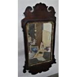 English fretwork wall mirror dating to the mid 18th century. The mirror frame is formed of thick