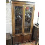 EDWARDIAN OAK BOOKCASE, leaded glass twin door, inset convex panes and twin cupboard base, 66"