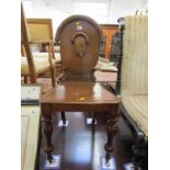 EDWARDIAN OAK HALL SEAT, carved shield back with inverted baluster legs