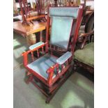 AMERICAN ROCKING ARMCHAIR, spindleback arm supports with blue upholstery