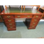 MAHOGANY KNEEHOLE DESK, reproduction twin pedestal kneehole desk of 9 drawers with green leather