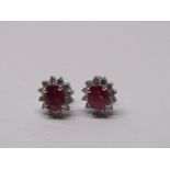PAIR OF 18CT GOLD DIAMOND & RUBY STUD EARRINGS, principal oval cut rubies surrounded by brilliant