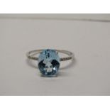9CT WHITE GOLD BLUE TOPAZ & DIAMOND RING, principal oval cut blue topaz of approximately 2ct with