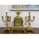 FRENCH CLOCK GARNITURE, 19th Century ornate brass cased mantel clock with pedestal urn pediment