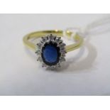 18ct YELLOW GOLD SAPPHIRE & DIAMOND RING, principal oval cut deep blue sapphire surrounded by