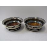SILVER DECANTER COASTERS, with turned hardwood bases, a matched pair, one HM Sheffield 1973, other