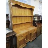 PINE DRESSER, contemporary pine kneehole dresser, with open plate rack, 52" width