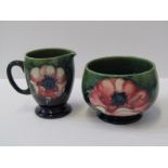 MOORCROFT, "Anemone" pattern green ground cream jug and similar sugar bowl (crudely repaired)