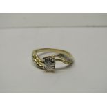9CT YELLOW GOLD DIAMOND SOLITAIRE RING, principal brilliant cut diamond with further accent illusion