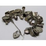 SILVER CHARM BRACELET, containing multiple silver charms including nuts, Noah's Ark, boogie boarder,