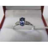 18ct WHITE GOLD SAPPHIRE & DIAMOND RING, principal pale blue oval cut sapphire with diamond set to