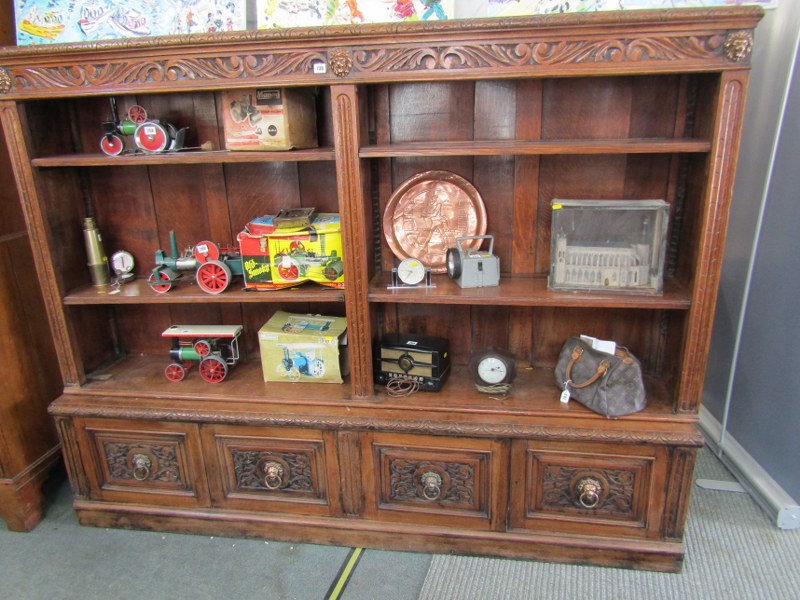 FLEMISH OAK OPEN FRONTED TWIN SECTION BOOKCASE, 4 cupboard base, embellished with copper lionmask - Image 2 of 2