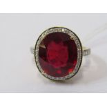 18ct YELLOW GOLD RUBY & DIAMOND CLUSTER RING, principal oval cut ruby surrounded by a halo of