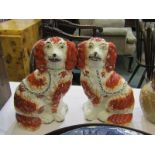 STAFFORDSHIRE POTTERY, pair of mid 19th Century Staffordshire seated Spaniels, terracotta colouring,