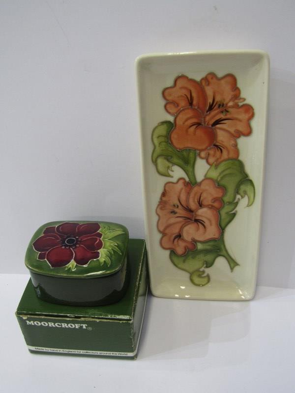 MOORCROFT, "Hibiscus" pattern rectangular pen tray and similar "Anemone" pattern green ground lidded