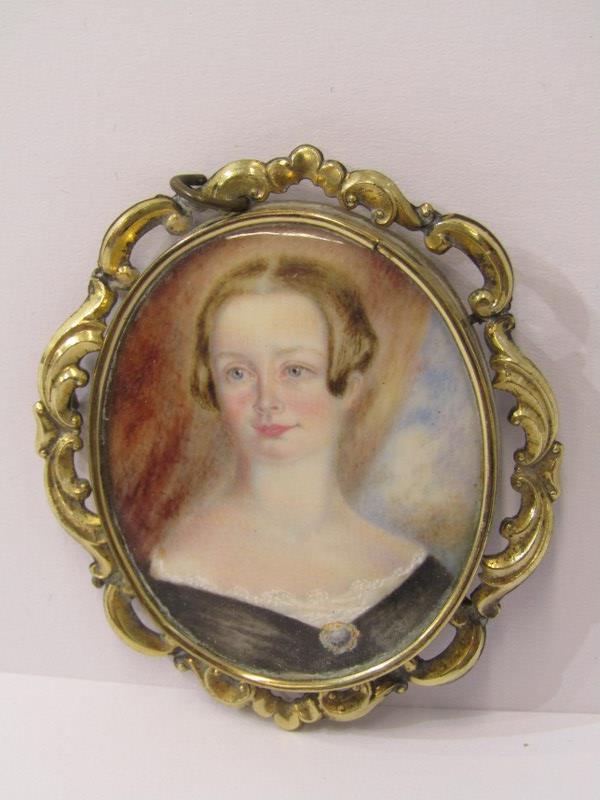 19th CENTURY PORTRAIT MINIATURE OF A YOUNG WOMAN on oval mother-of-pearl plaque in a foliate