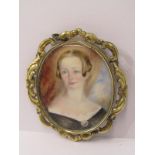 19th CENTURY PORTRAIT MINIATURE OF A YOUNG WOMAN on oval mother-of-pearl plaque in a foliate