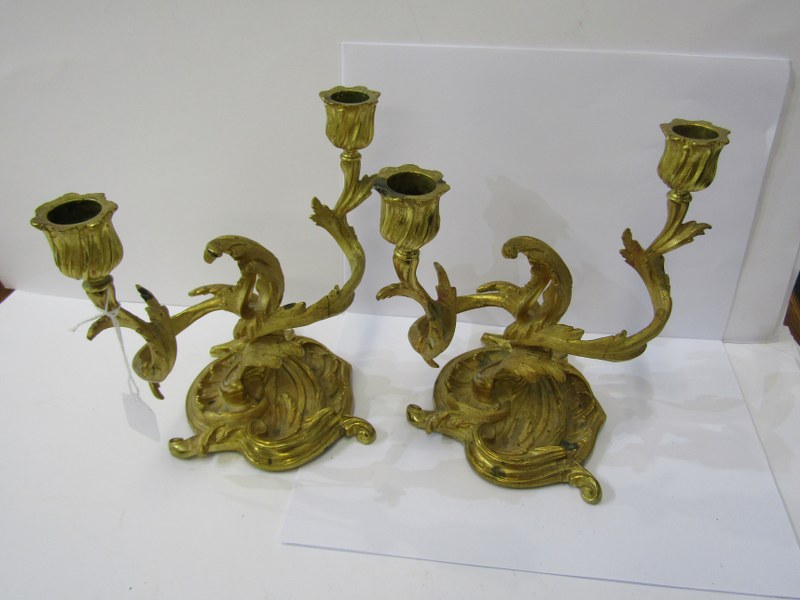 ROCOCO CANDELABRA, A pair of gilded twin branch foliate design candelabra, 18" height