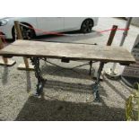 RUSTIC GARDEN TABLE, with large planked top on ornate Victorian cast iron base with masked
