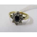 18CT YELLOW GOLD SAPPHIRE & DIAMOND CLUSTER RING, principal oval cut dark blue sapphire surrounded