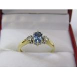 18ct YELLOW GOLD 3 STONE SAPPHIRE & DIAMOND RING, principal pale blue oval cut sapphire with