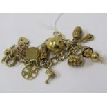 9ct YELLOW GOLD CHARM BRACELET, multi charms including globe, barrel, Maltese Cross, chick with