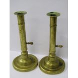 GEORGIAN BRASSWARE, A pair of circular base brass ejector candle sticks, 7" height