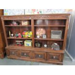 FLEMISH OAK OPEN FRONTED TWIN SECTION BOOKCASE, 4 cupboard base, embellished with copper lionmask