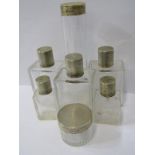 SET OF SILVER TOPPED PERFUME BOTTLES, 7 circular and square form glass jars with silver lids with