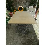 WROUGHT IRON PATIO TABLE with composite stone top, 59" x 37"