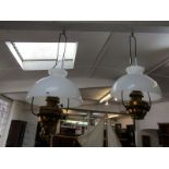 HANGING OIL LAMPS, pair of Edwardian brass framed oil lamps with opaque glass shades & wrought