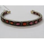 SILVER STONESET ARTICULATED HINGED BRACELET set with oval cut graduated red stone possibly garnet