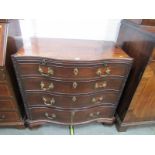 GEORGIAN SERPENTINE FRONTED CHEST OF DRAWERS, blind fretwork canted corners with brushing slide