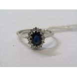 18ct WHITE GOLD & SAPPHIRE & DIAMOND CLUSTER RING, principal oval cut dark blue sapphire, surrounded