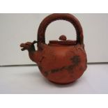 ORIENTAL CERAMICS, a dragon handled relief decorated redware tea kettle and lid, impressed base