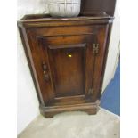 GEORGIAN DESIGN OAK CORNER CUPBOARD, panelled door with shaped brass hinges and escutcheons and