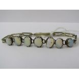 OPAL SET SILVER BRACELET, 7 oval cut opals with good colour set in vintage silver bracelet with
