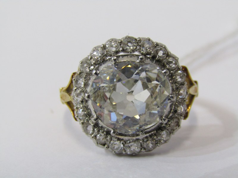 IMPRESSIVE 18ct YELLOW GOLD DIAMOND RING, principal old cushion cut diamond surrounded by further