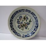 18th CENTURY ENGLISH DELFT, 9" circular dish decorated with stylised floral centre and geometric