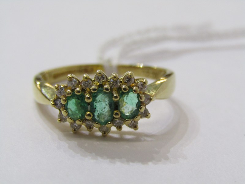 18ct YELLOW GOLD EMERALD & DIAMOND 3 STONE RING, 3 pricipal graduated oval cut emeralds surrounded - Image 2 of 6