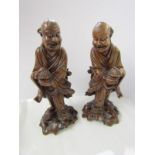 ORIENTAL CARVINGS, pair of carved cherry root figures of men with wicker caskets, 13.5" height